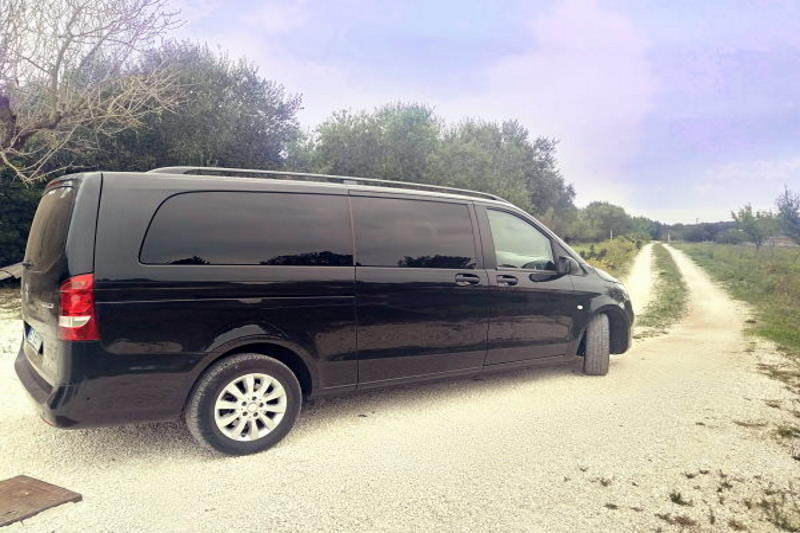 black Mercedes minivan in Puglia countryside road