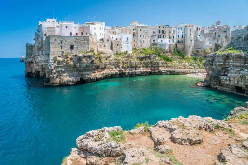 view of Polignano a Mare old town from the rugged coastline